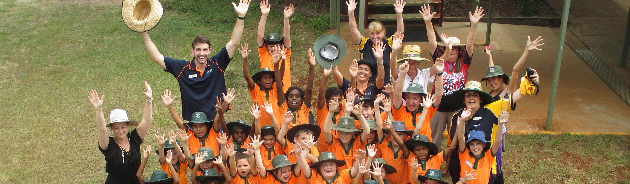 Mount Garnet State School students standing in a group with their arms in the air